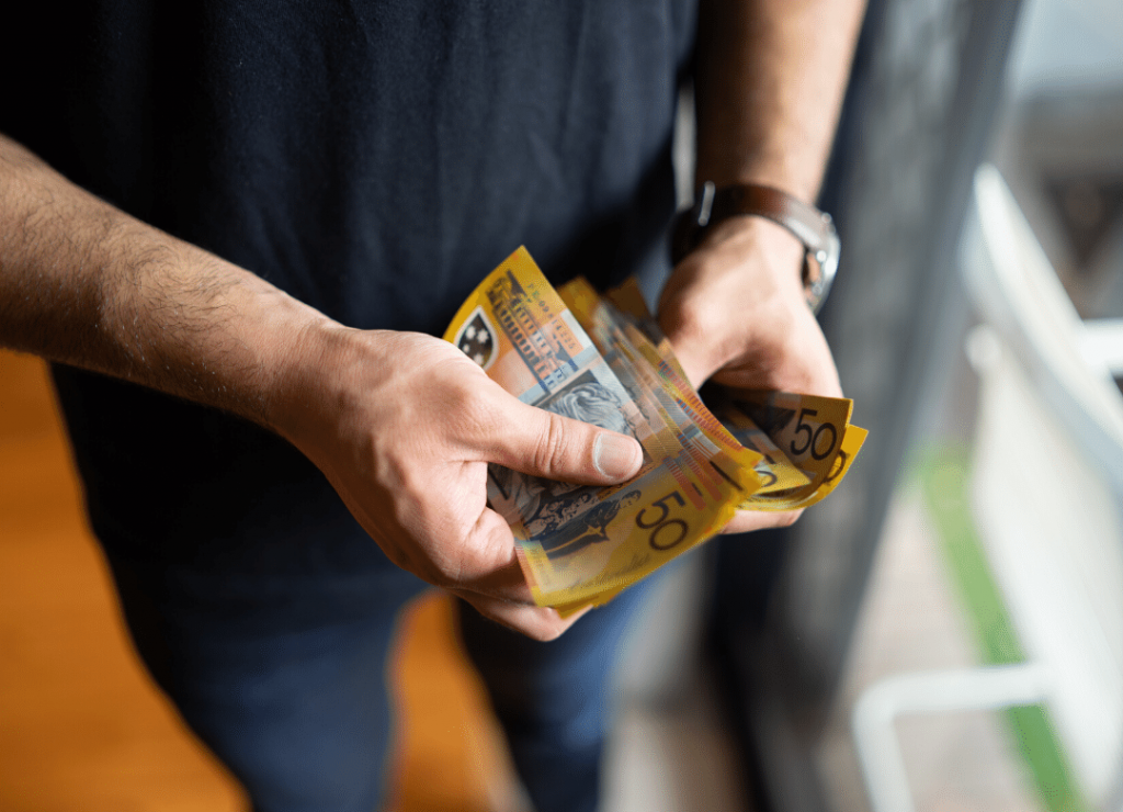 Photo of a man holding money in his hands