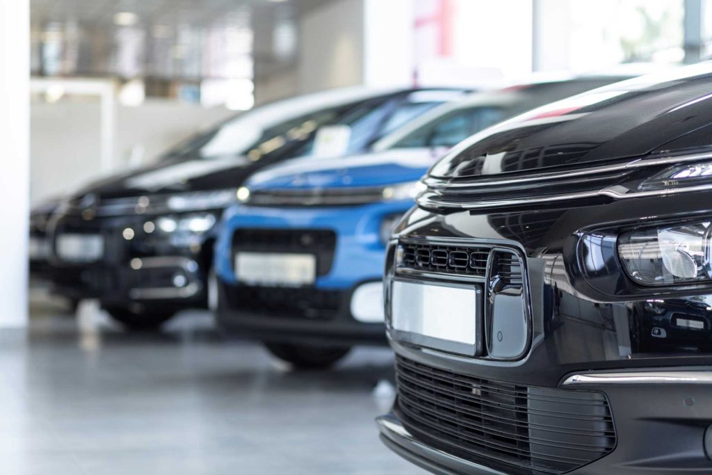 Low angle of cars in a showroom | Featured image for What Kind of a Car Should I Buy blog from eCarz.